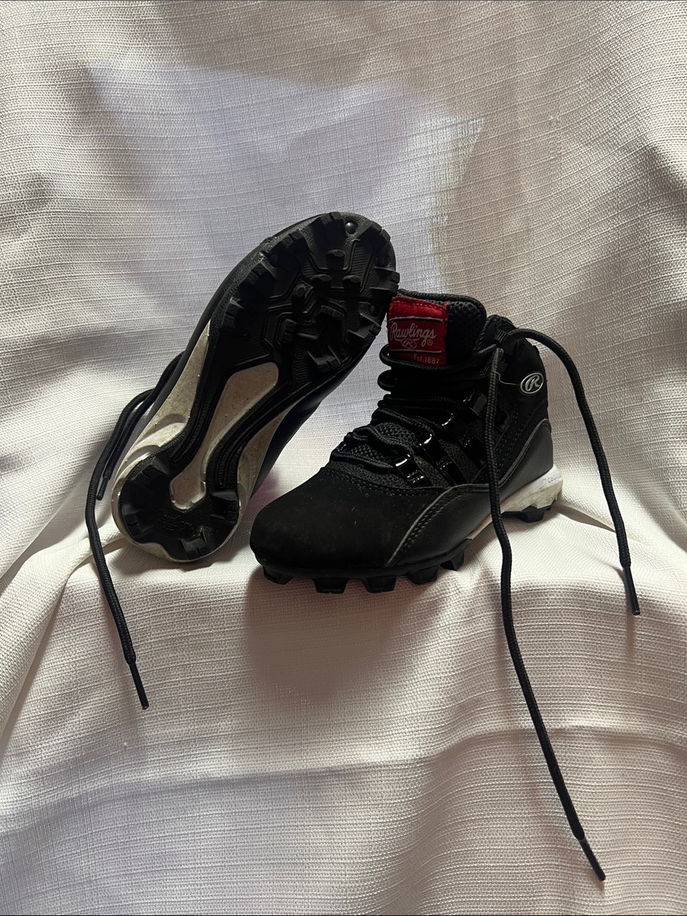 Rawlings Black Youth Baseball Cleats with Red Accent